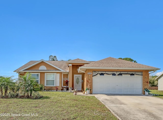 view of front of house featuring a garage and a front yard