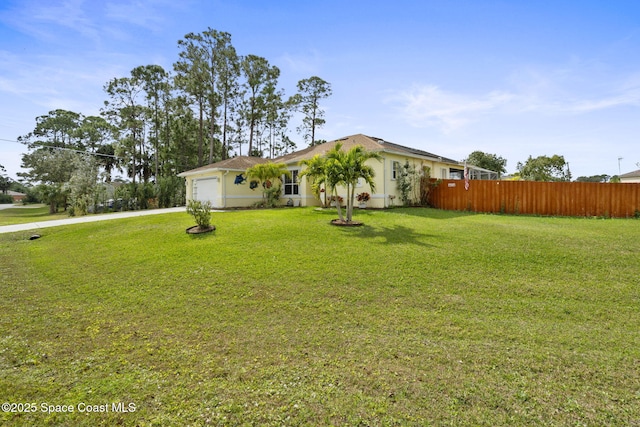 ranch-style home with a garage and a front lawn