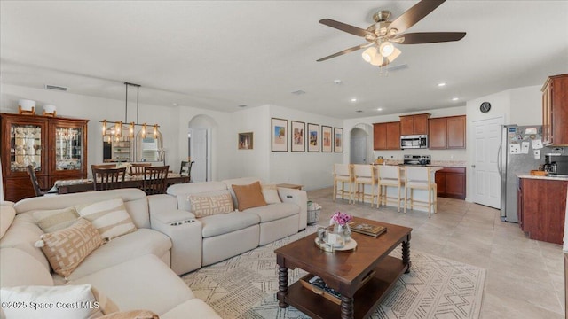 tiled living room featuring ceiling fan