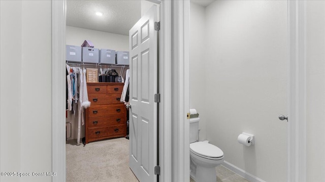 bathroom featuring toilet and a textured ceiling