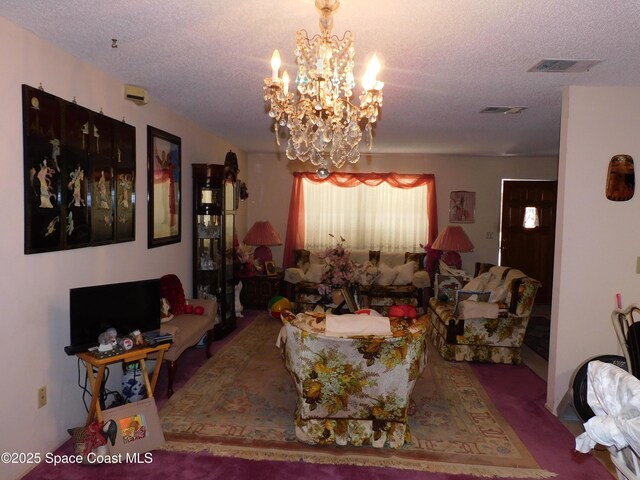 dining space with an inviting chandelier and a textured ceiling