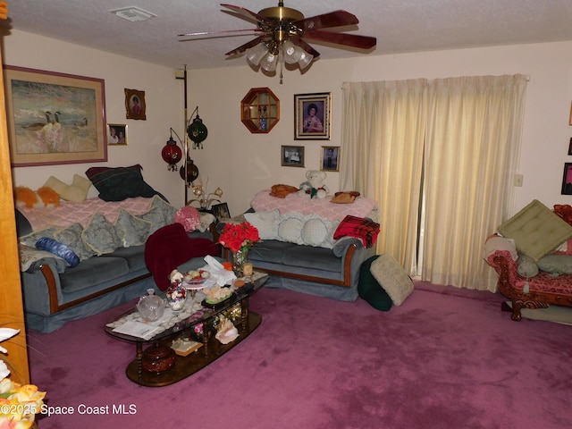 bedroom with ceiling fan, carpet flooring, and a textured ceiling