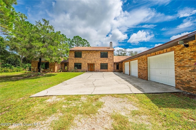 rear view of house with a garage and a yard