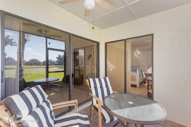 sunroom featuring ceiling fan