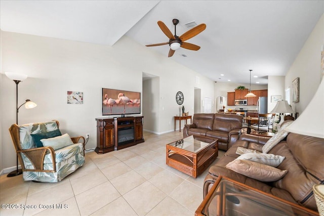 tiled living room with lofted ceiling and ceiling fan