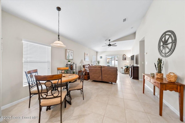 dining room with ceiling fan, high vaulted ceiling, and light tile patterned floors