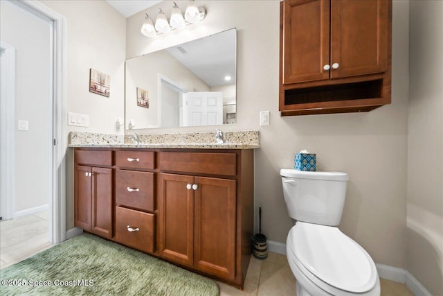 bathroom featuring vanity, tile patterned floors, and toilet