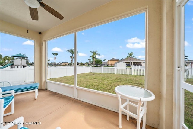 sunroom / solarium featuring ceiling fan