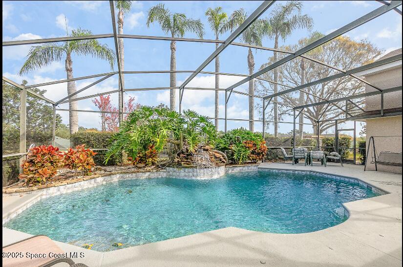 view of swimming pool featuring a lanai and a patio