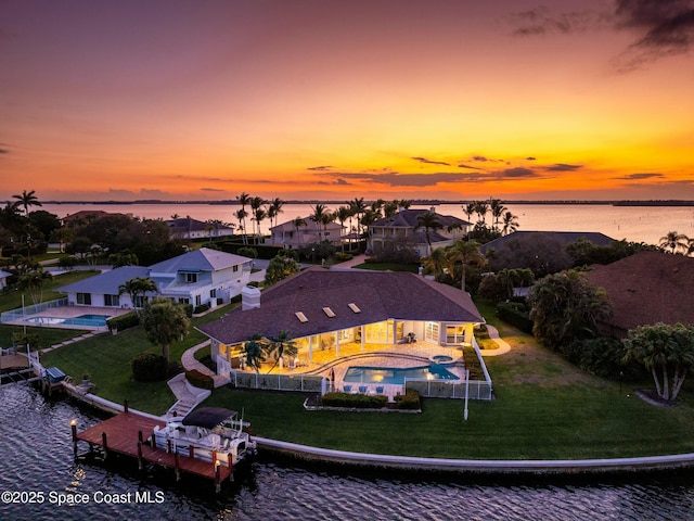 aerial view at dusk with a water view