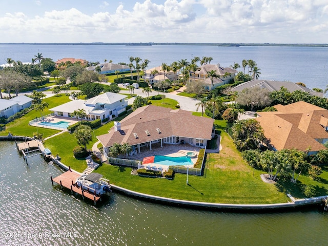 birds eye view of property with a water view