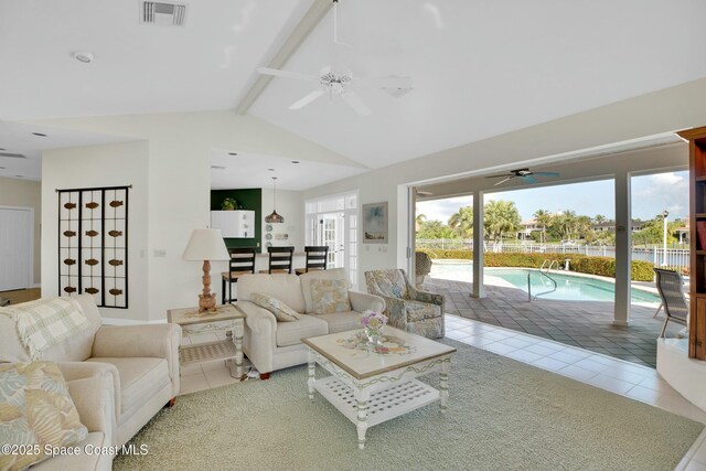 living room featuring vaulted ceiling with beams, tile patterned floors, and ceiling fan