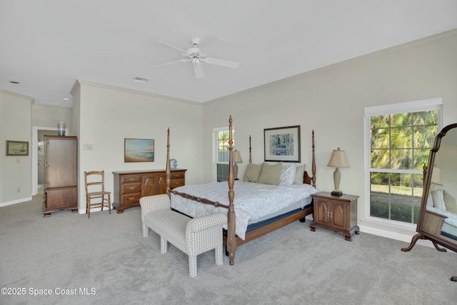 bedroom with multiple windows, ornamental molding, and light colored carpet