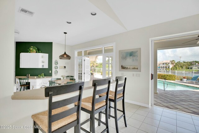 tiled dining room featuring french doors