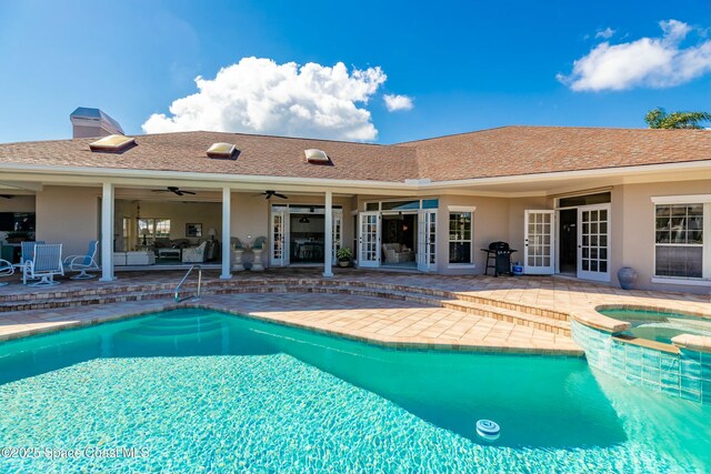 view of swimming pool with an in ground hot tub, area for grilling, ceiling fan, and a patio area