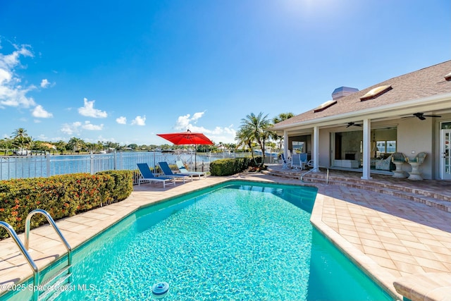 view of swimming pool with a patio and ceiling fan