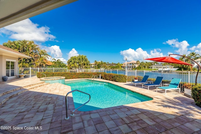 view of pool with an in ground hot tub, a patio, and a water view