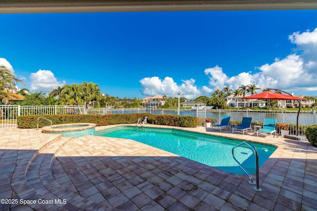 view of swimming pool featuring a water view, an in ground hot tub, and a patio