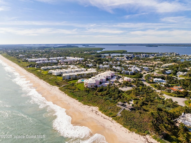 birds eye view of property featuring a water view and a view of the beach