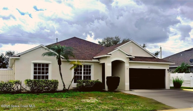 ranch-style house featuring a garage, fence, concrete driveway, and stucco siding