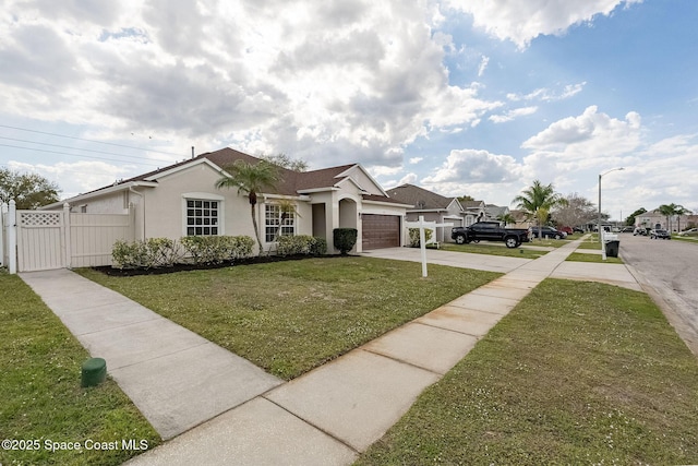 view of front of property featuring concrete driveway, a front yard, an attached garage, and stucco siding