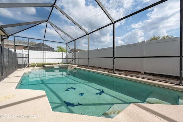 view of pool with glass enclosure, a patio area, fence, and a pool with connected hot tub