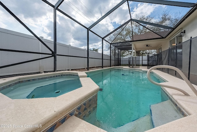 view of swimming pool with a lanai, a patio area, a fenced backyard, and a pool with connected hot tub