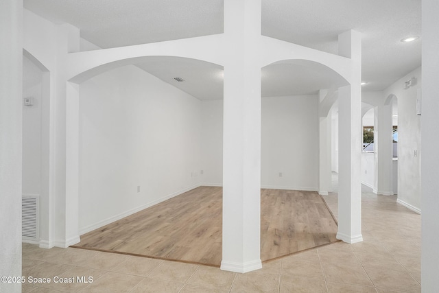 tiled empty room featuring recessed lighting, visible vents, and baseboards