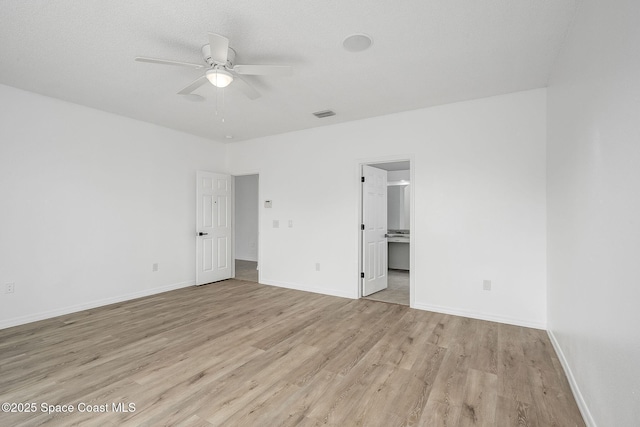 unfurnished bedroom with light wood-style floors, visible vents, and baseboards