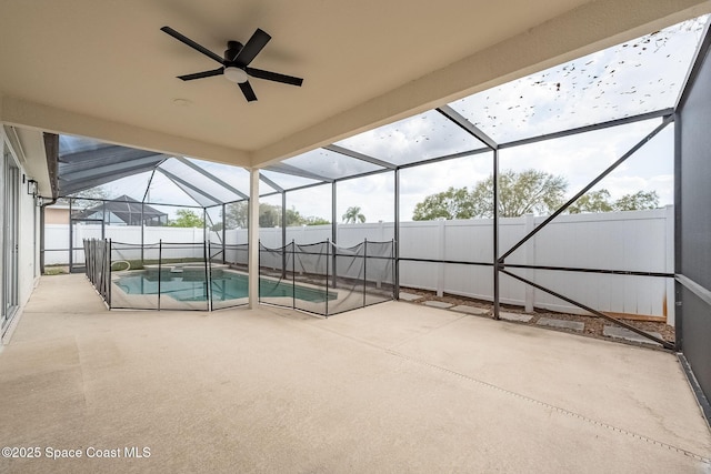 view of pool with a ceiling fan, a fenced in pool, a patio, glass enclosure, and a fenced backyard