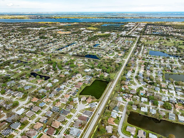 drone / aerial view featuring a residential view and a water view