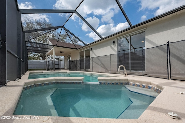 view of swimming pool with a patio area, fence, a pool with connected hot tub, and a lanai