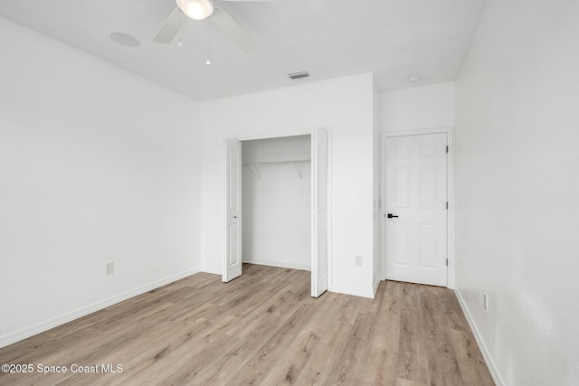 unfurnished bedroom featuring a closet, visible vents, light wood-style flooring, and baseboards