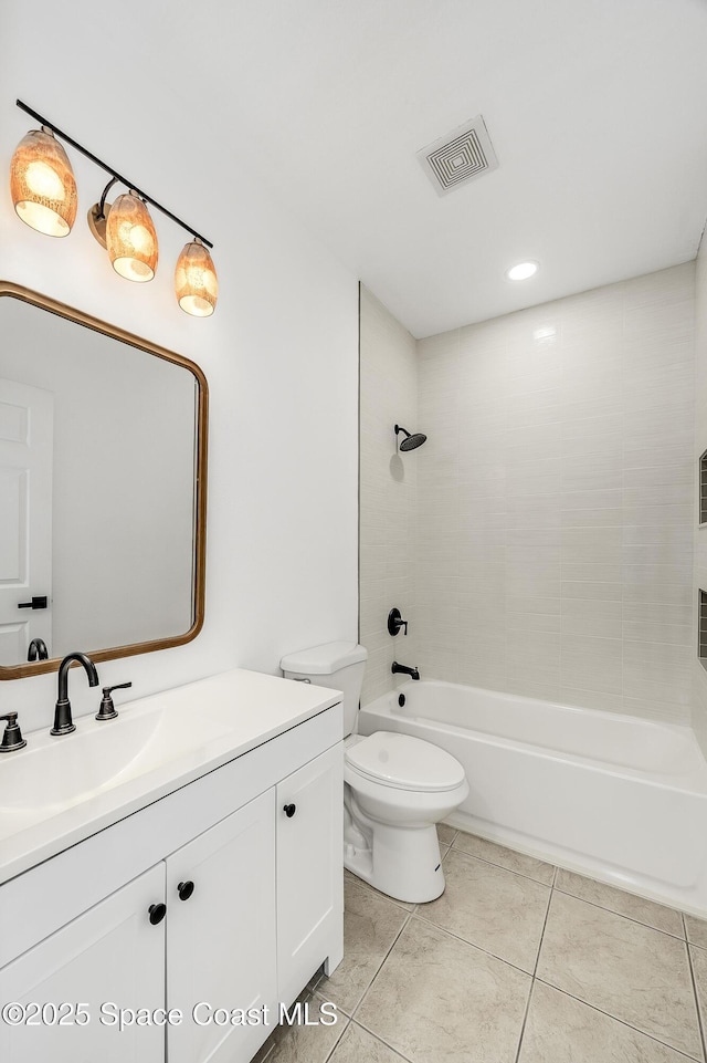 bathroom with shower / bathtub combination, visible vents, toilet, vanity, and tile patterned floors