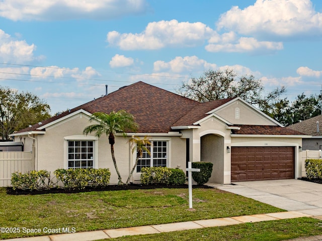 single story home featuring stucco siding, an attached garage, a front yard, fence, and driveway