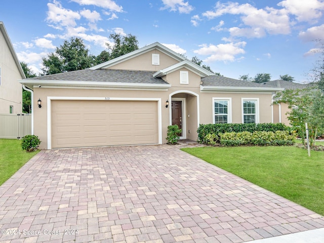 view of front of house featuring a garage and a front lawn