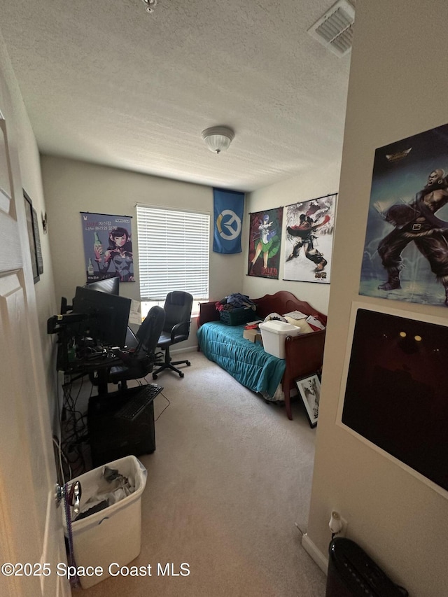 bedroom with carpet and a textured ceiling