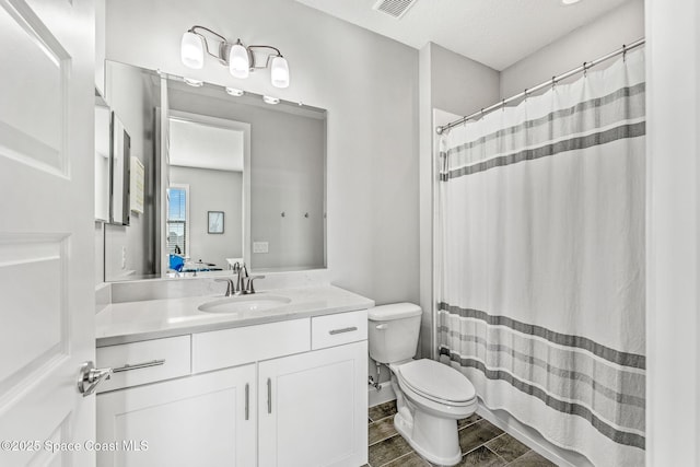 bathroom with visible vents, toilet, a shower with curtain, wood tiled floor, and vanity