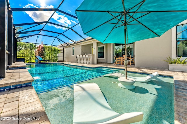 outdoor pool featuring a patio and glass enclosure