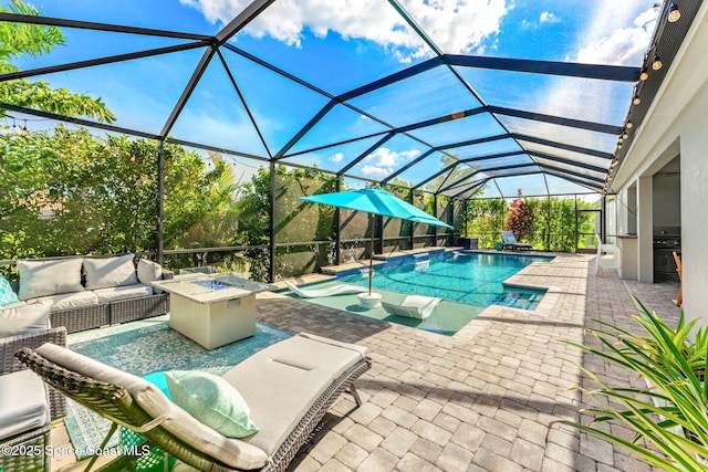 outdoor pool with a lanai, a patio area, and an outdoor living space with a fire pit