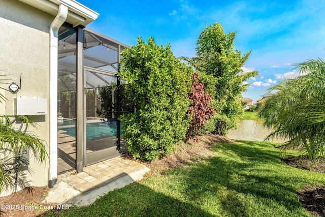 view of yard featuring a lanai and an outdoor pool