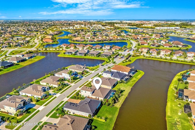 birds eye view of property with a water view and a residential view