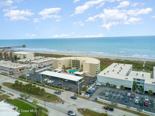 birds eye view of property featuring a water view and a view of the beach