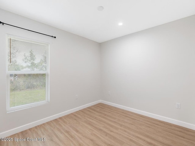 spare room with light hardwood / wood-style flooring