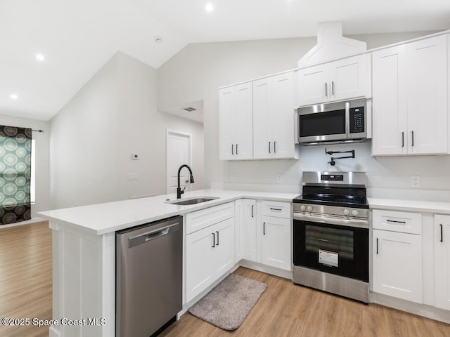 kitchen with appliances with stainless steel finishes, sink, and white cabinets