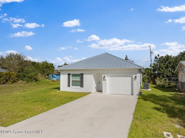 ranch-style home featuring cooling unit, a garage, and a front lawn