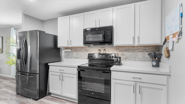 kitchen with backsplash, black appliances, light hardwood / wood-style floors, and white cabinets