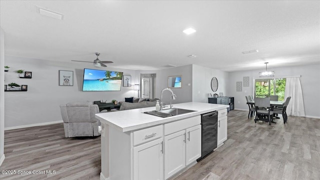 kitchen with sink, white cabinetry, black dishwasher, an island with sink, and light hardwood / wood-style floors