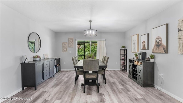 dining area featuring a chandelier and light hardwood / wood-style floors