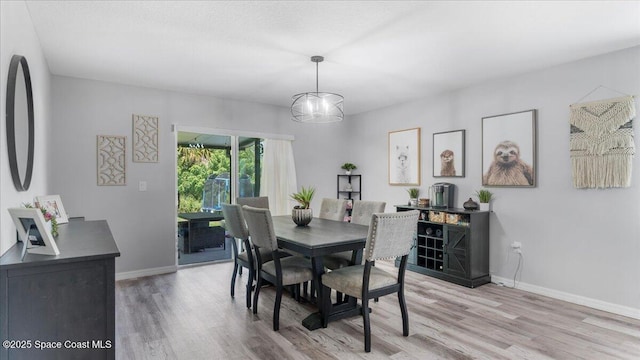 dining room featuring light hardwood / wood-style floors and a notable chandelier